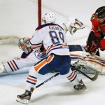 Oilers begin road trip with OT loss to relentless Hawks