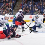 Jannik Hansen #36 of the Vancouver Canucks and Cam Atkinson #13 of the Columbus Blue Jackets battle for a loose puck in front of the net during the first period on March 12, 2013 at Nationwide Arena in Columbus, Ohio. (Photo by Jamie Sabau/NHLI via Getty Images)