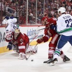 Goaltender Mike Smith #41 of the Phoenix Coyotes is hit from behind from Alexander Edler #23 of the Vancouver Canucks during the second period of the NHL game at Jobing.com Arena on March 21, 2013 in Glendale, Arizona. Edler received a 5 minute major penalty on the play.(Photo by Christian Petersen/Getty Images)