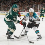 Devin Setoguchi #10 of the Minnesota Wild shoots the puck with Scott Gomez #23 of the San Jose Sharks defending during the game on March 23, 2013 at the Xcel Energy Center in Saint Paul, Minnesota. (Photo by Bruce Kluckhohn/NHLI via Getty Images)