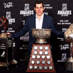 Evgeni Malkin of the Pittsburgh Penguins posing with the Hart Memorial Trophy among others after being named the recipient following the 2011-2012 season